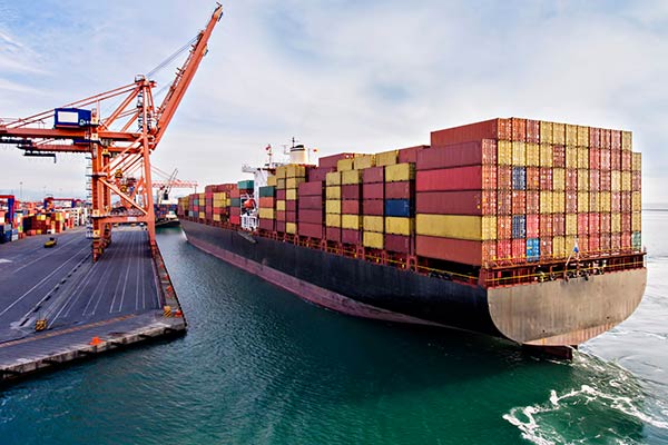 Barge loaded with shipping containers waiting to be unloaded